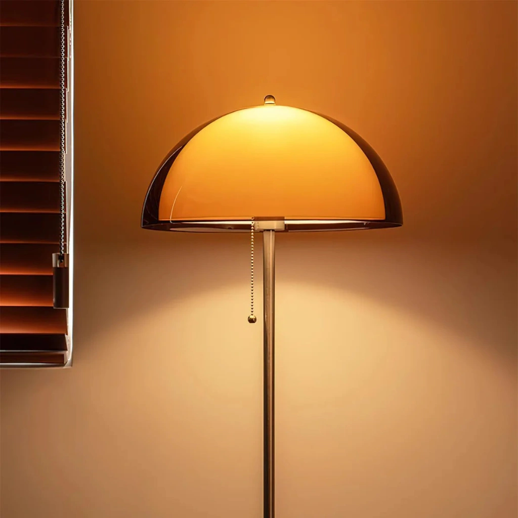 Close-up of illuminated amber acrylic mushroom shade and upper pole