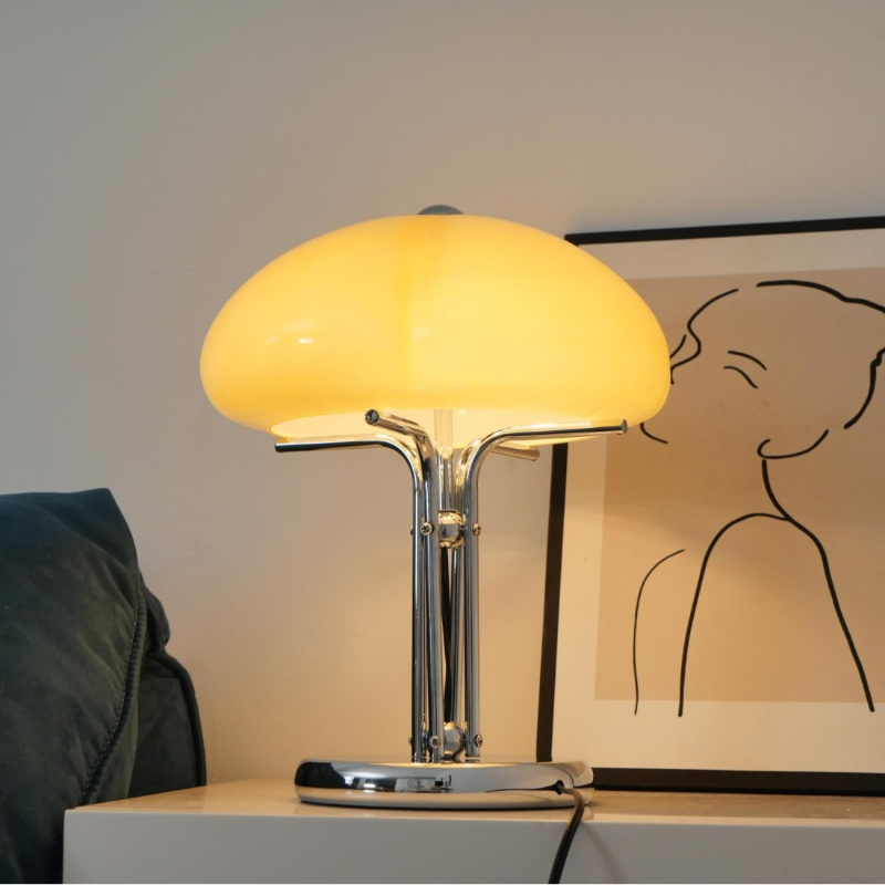 Lit Hector lamp on a white side table with sofa background