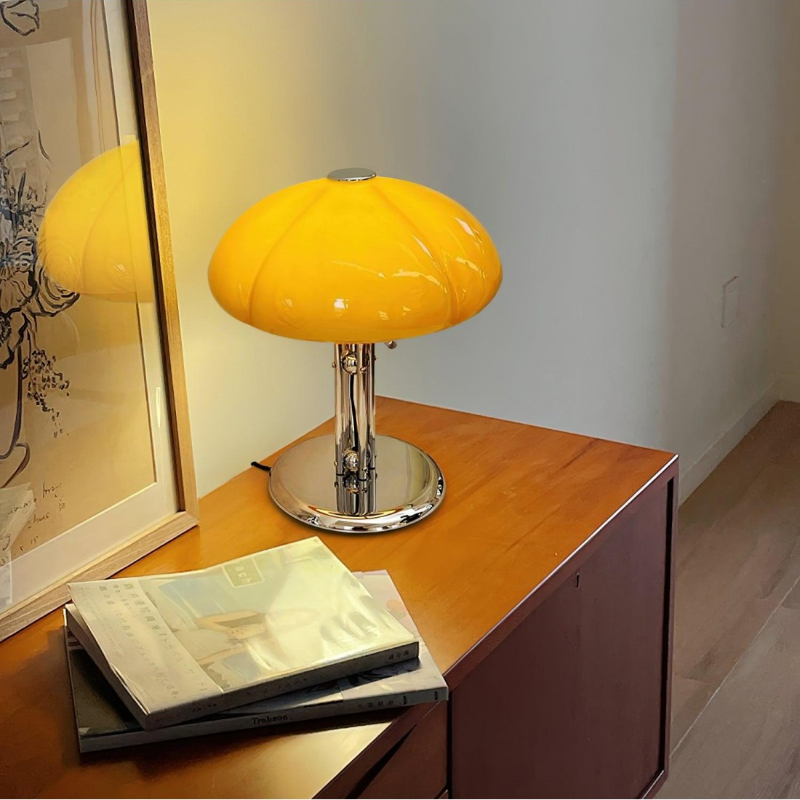 Orange Hector lamp on wooden cabinet with surrounding objects