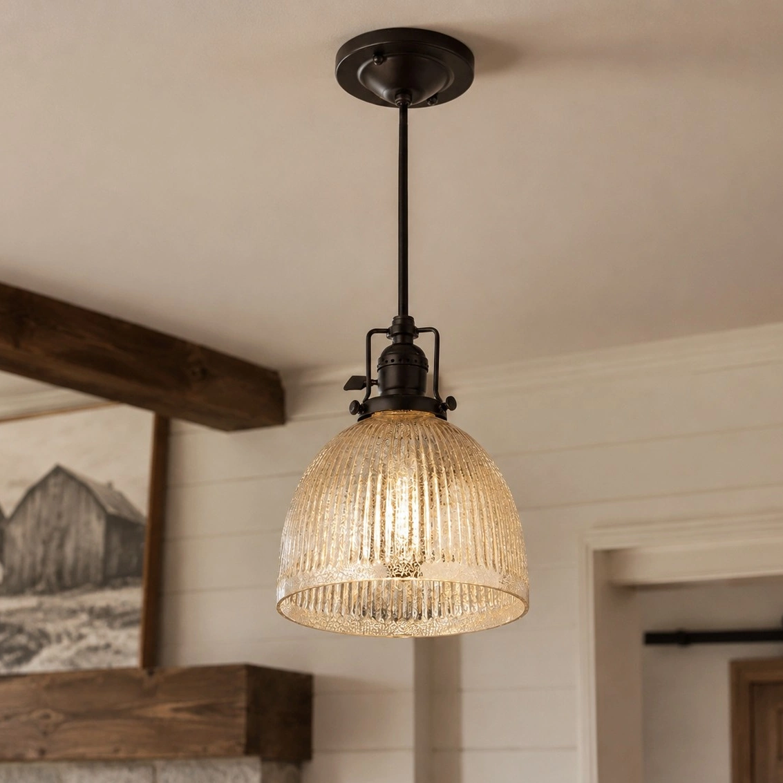 Pendant light showing cord, canopy, dark fixture, and glowing glass shade