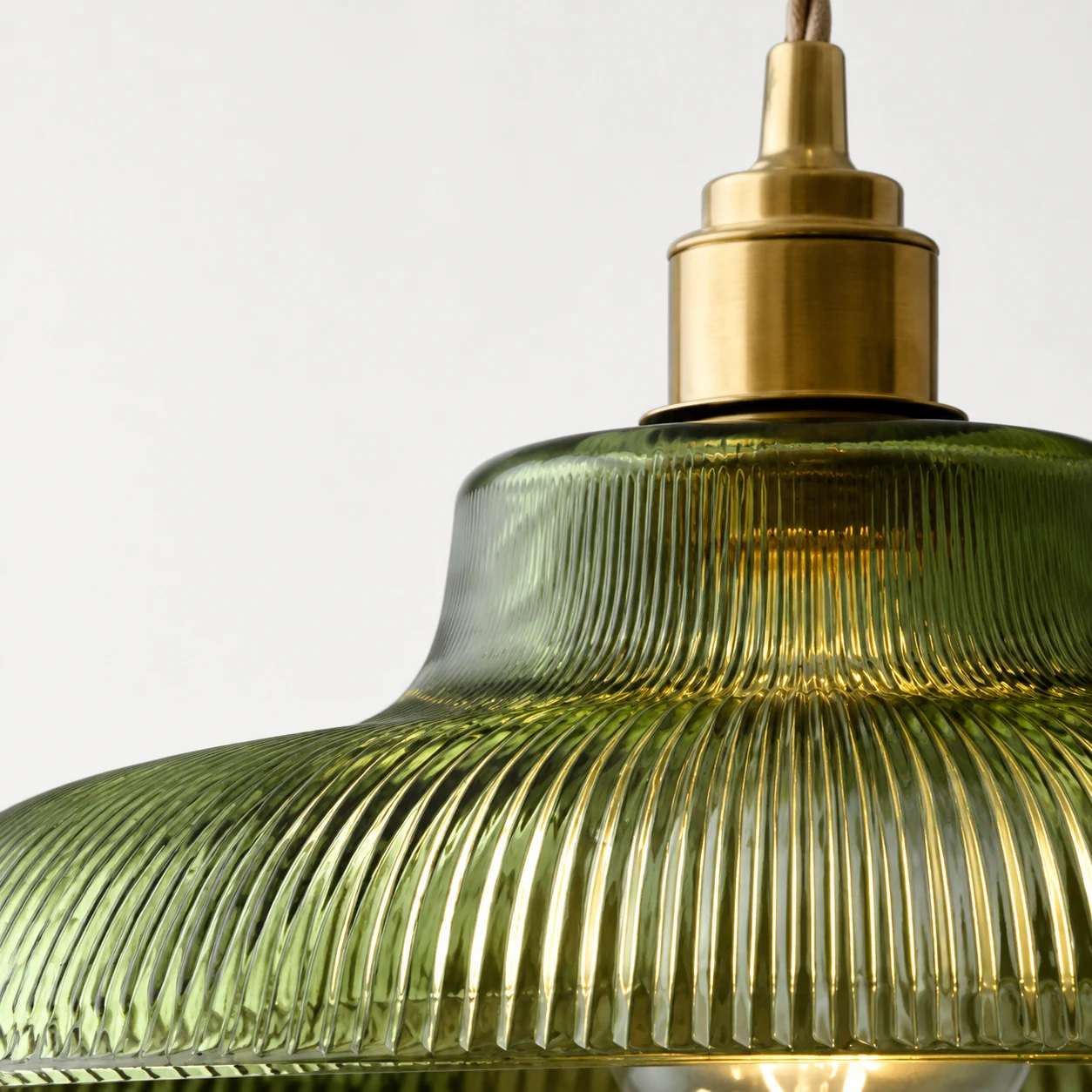 Close view of Avard ribbed glass and brass pendant detail