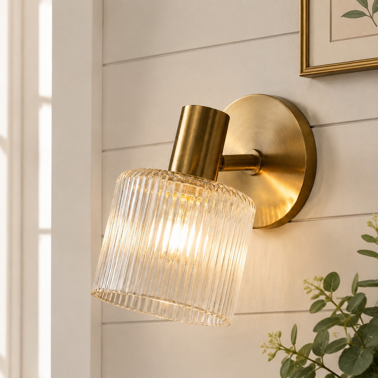Installed Malcolm brass cylinder glass wall sconce close-up in a room setting
