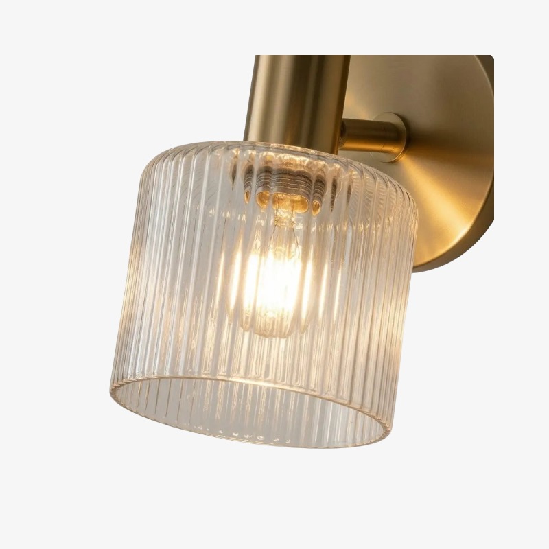 Close-up of the ribbed glass shade and brass finish on the Malcolm wall sconce