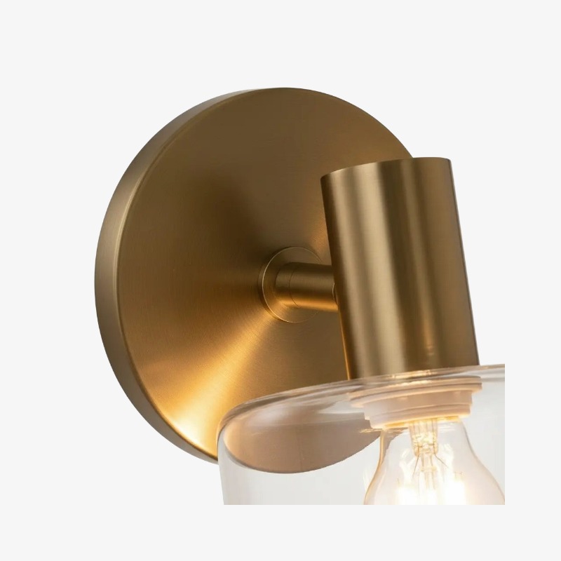 Close-up of the brass backplate arm socket and glass attachment on the Malcolm wall sconce