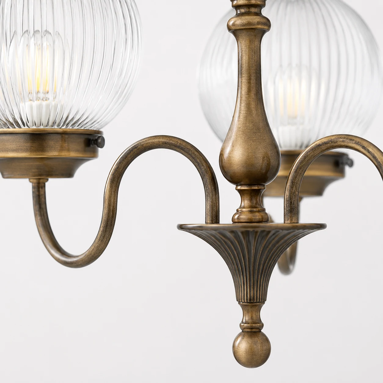 Close-up detail of Vanessa chandelier ribbed glass and antique brass hardware