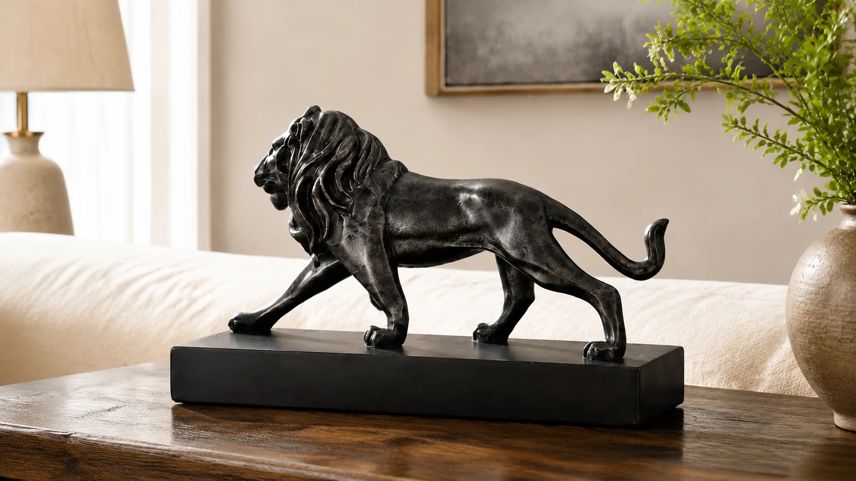 Graham black resin lion tabletop sculpture in a modern room scene