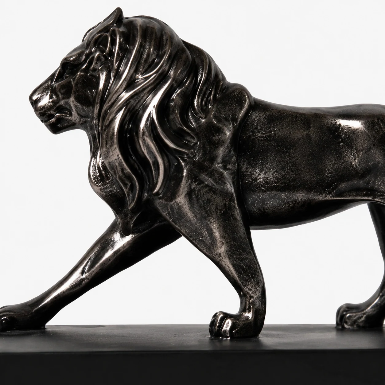 Close-up of the black resin lion sculpture finish and carved detail