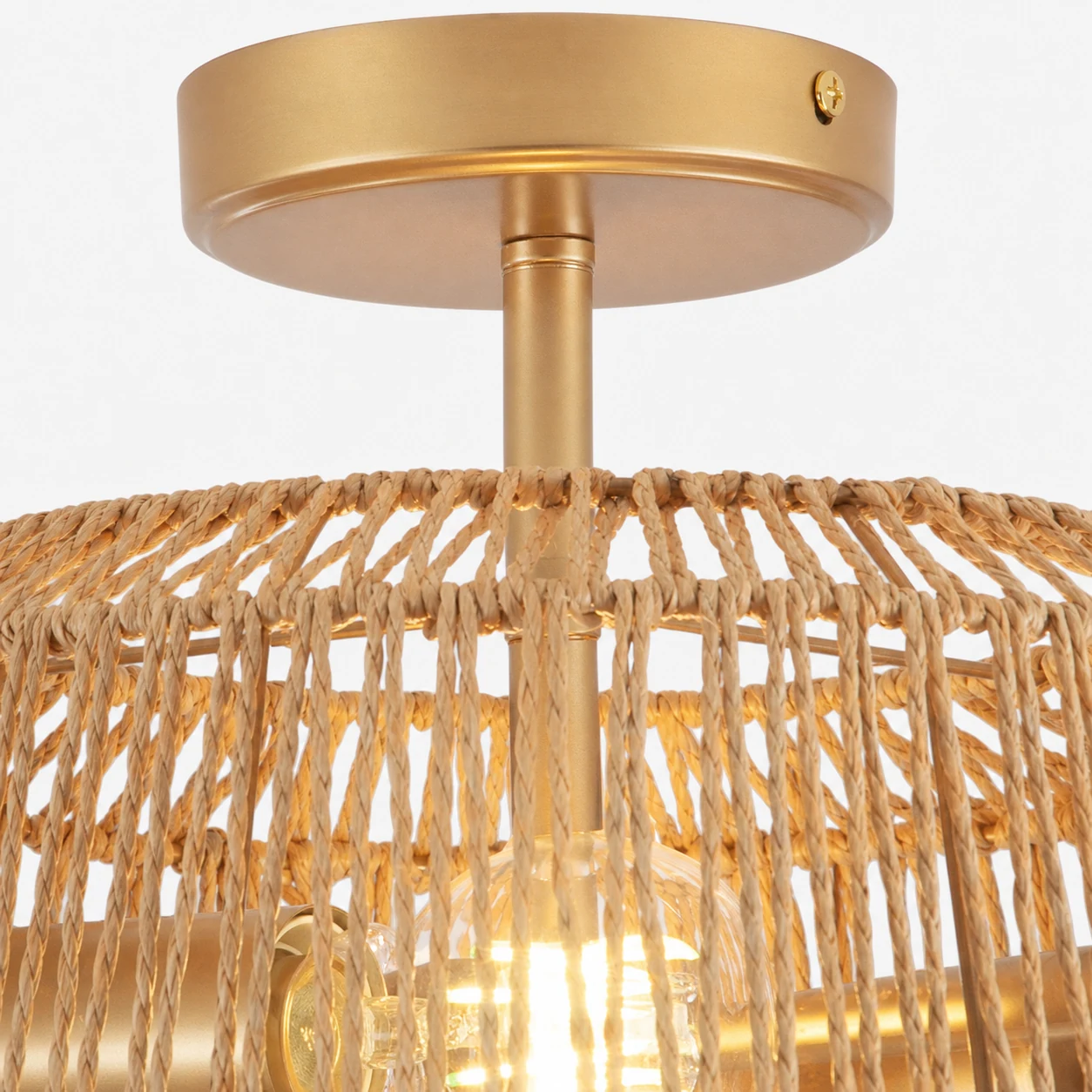Close-up of the rattan texture and brass-toned detail on the Kulkarni ceiling light