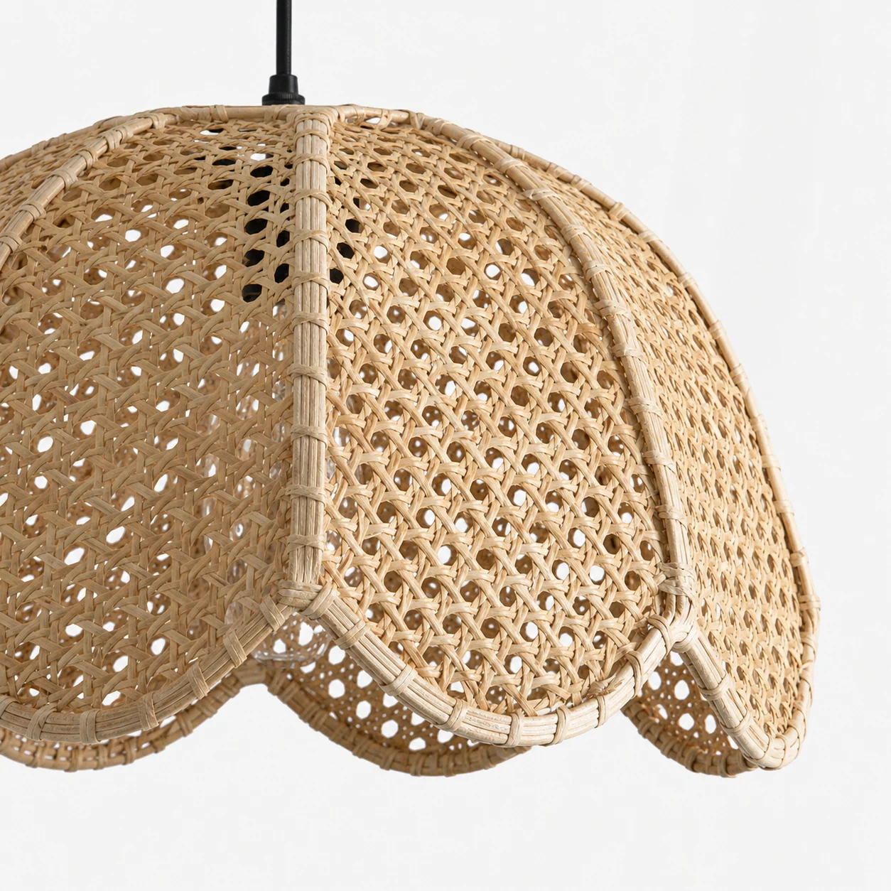 Close-up of woven rattan texture on the Kumar scalloped pendant shade