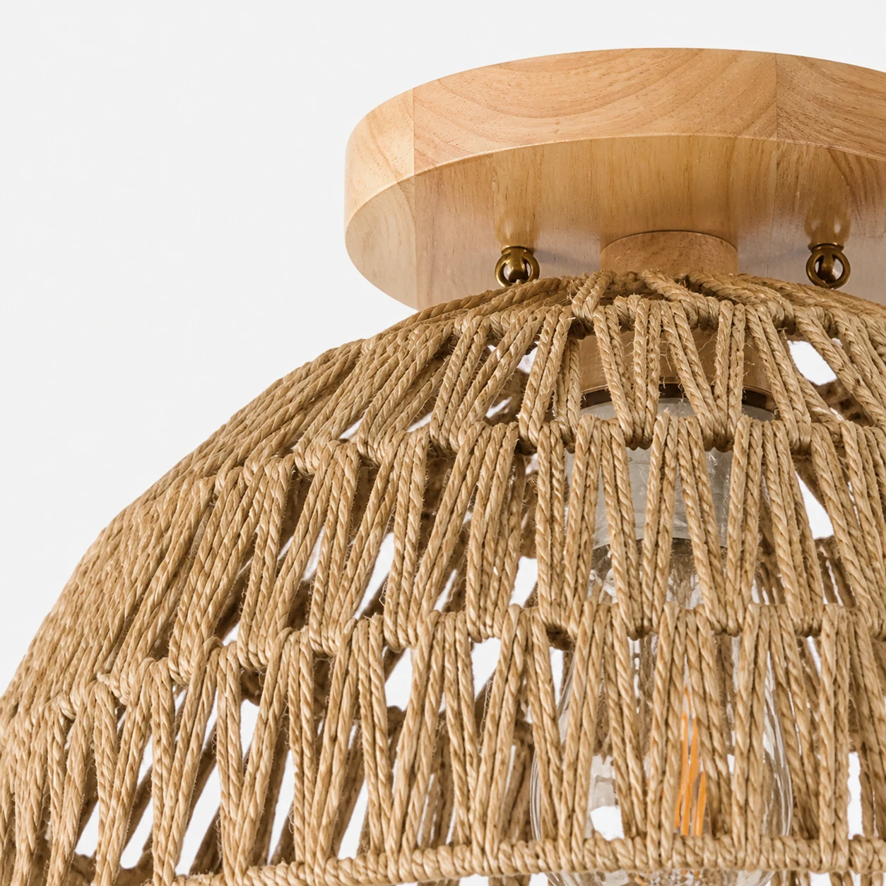 Close-up of the paper rope weave and warm wood detail on the Kartik dome ceiling light