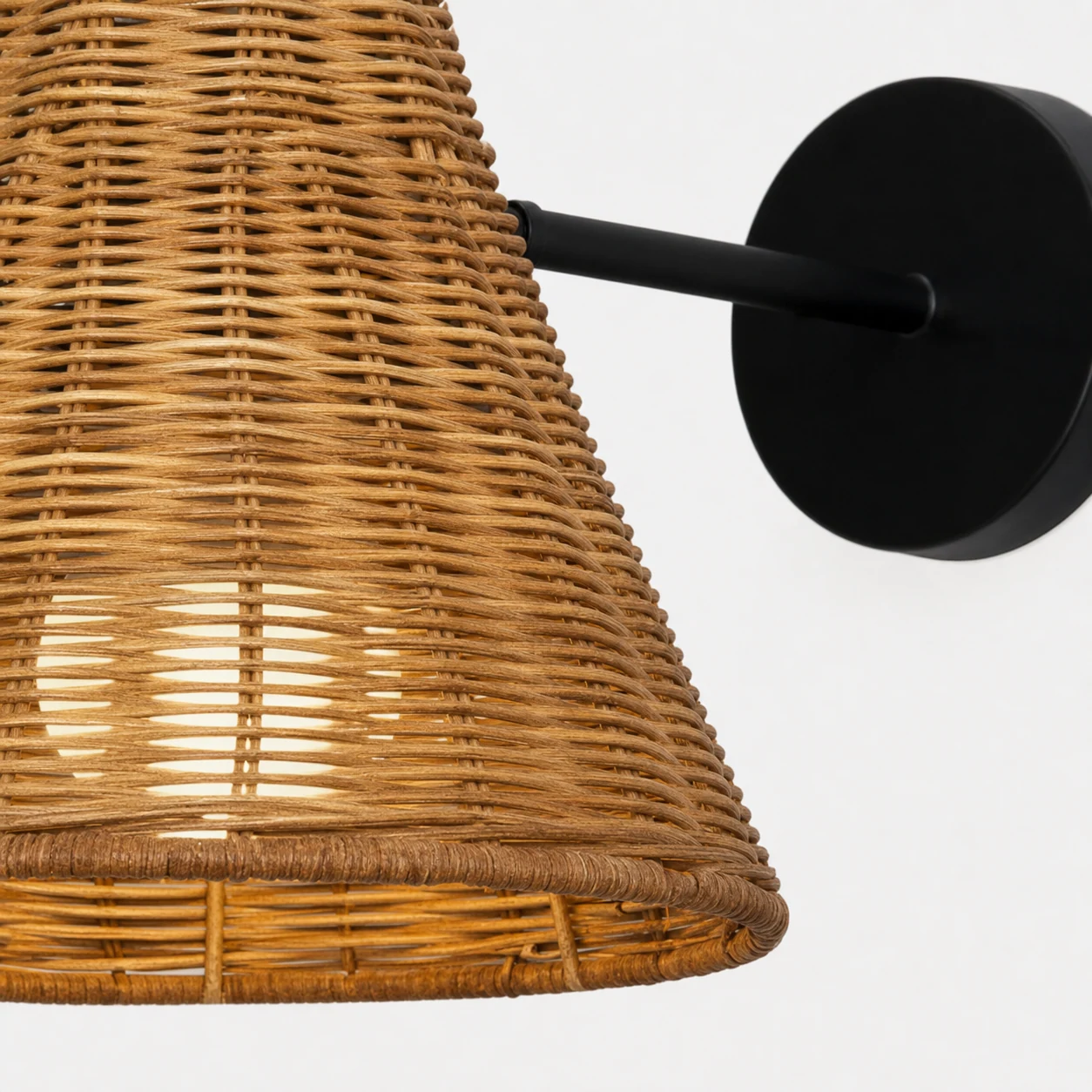 Close-up detail of the rattan texture and conical shade construction
