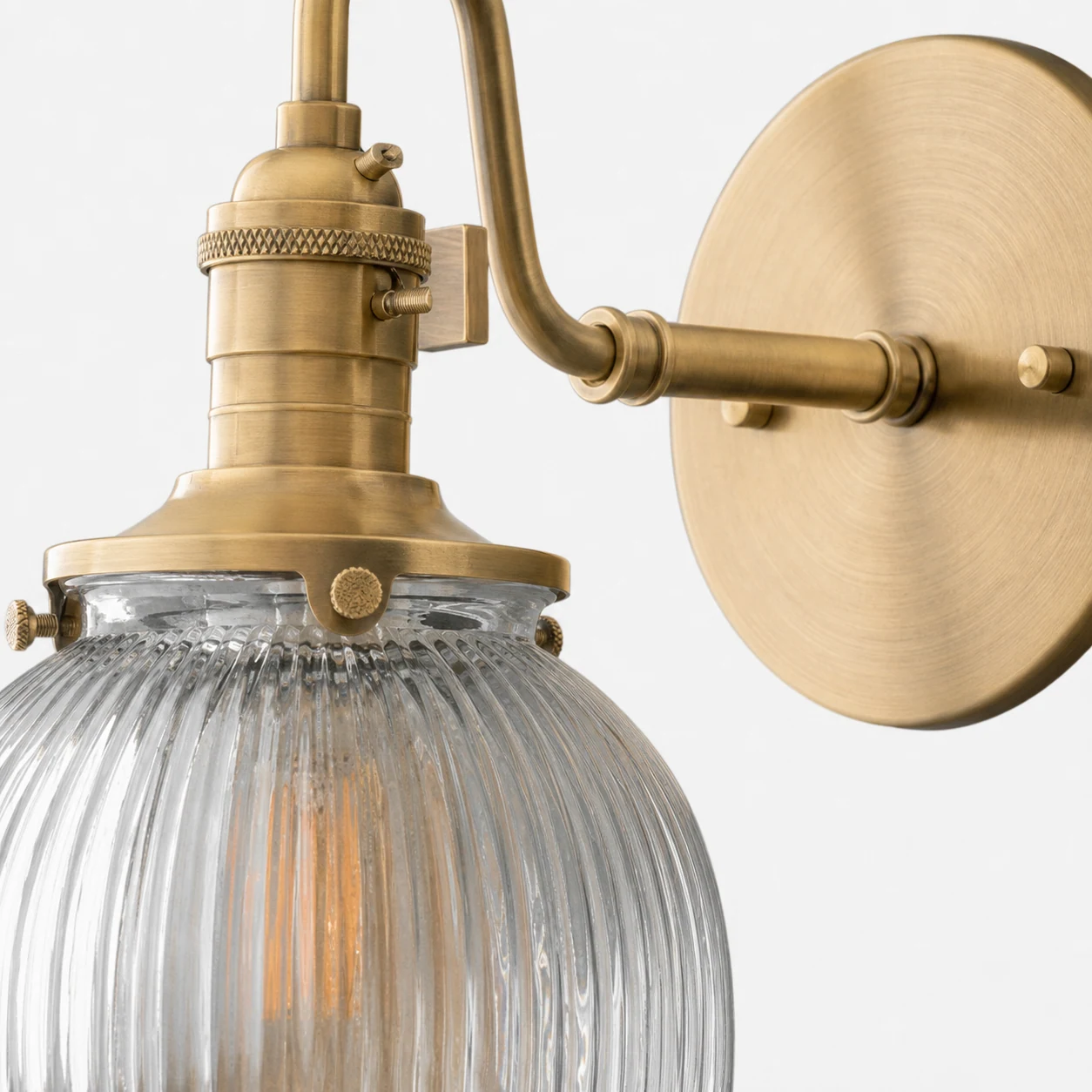 Close detail of the SCONCE MODEL NO. 3331 brass finish and ribbed glass