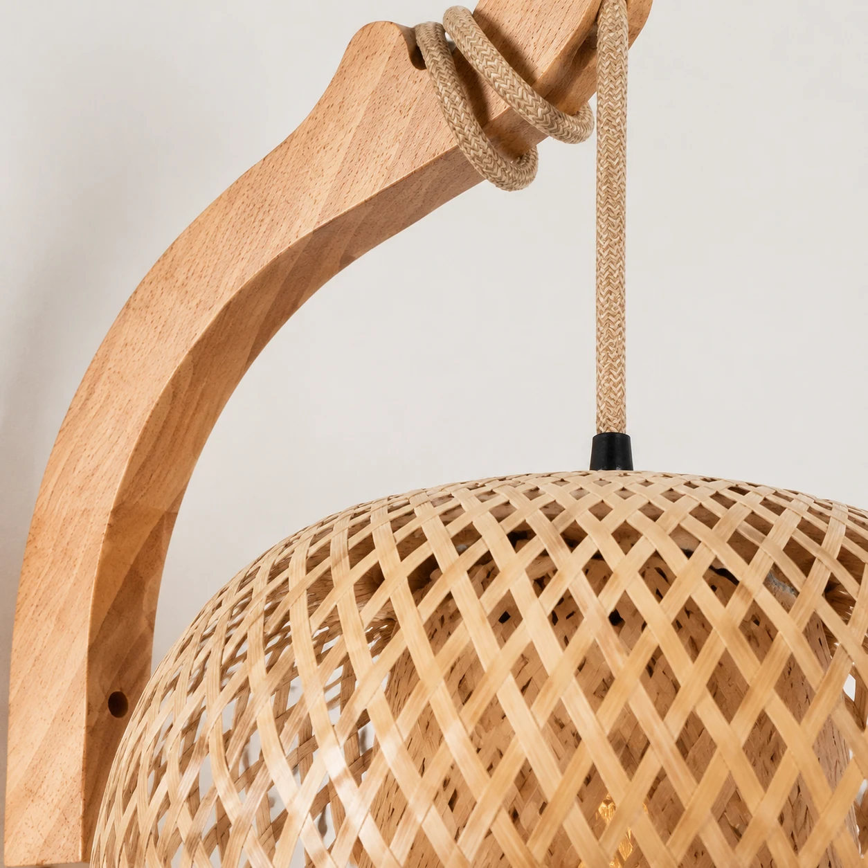 Close-up detail of the Jimmy wall sconce rattan shade and warm natural finish
