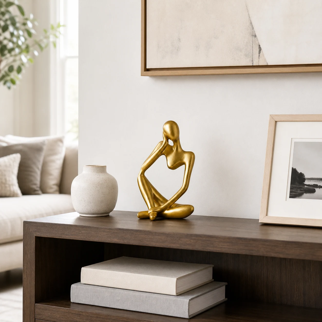 Gold abstract thinker sculpture styled in a refined interior