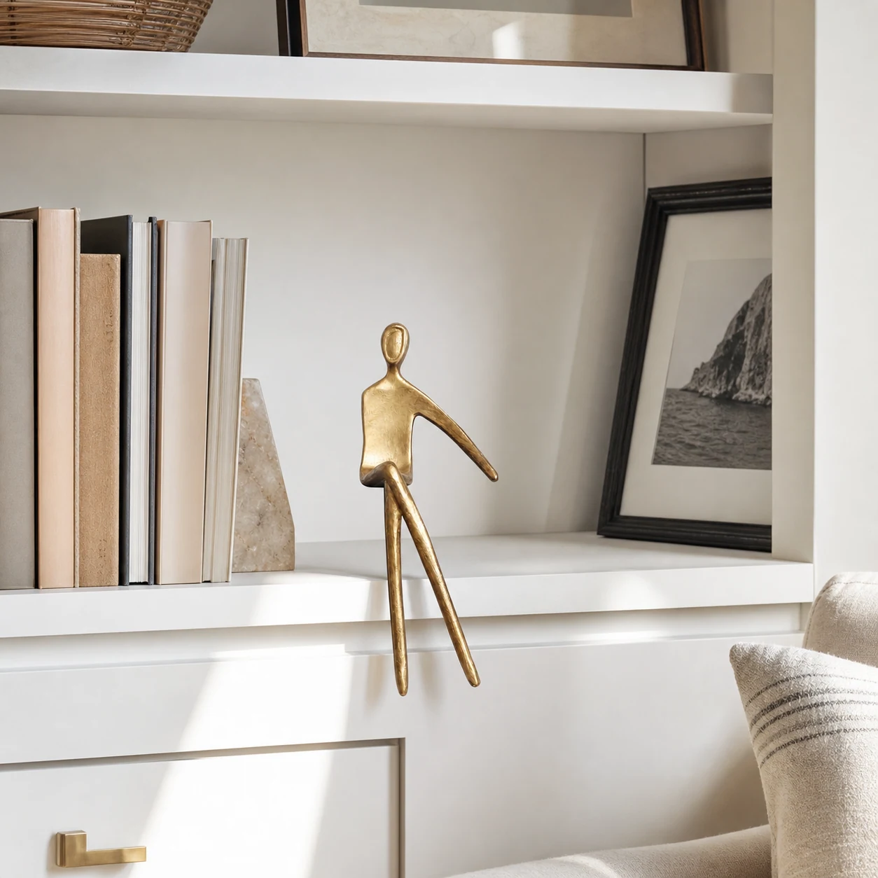 Gold elongated geometric figure beside books