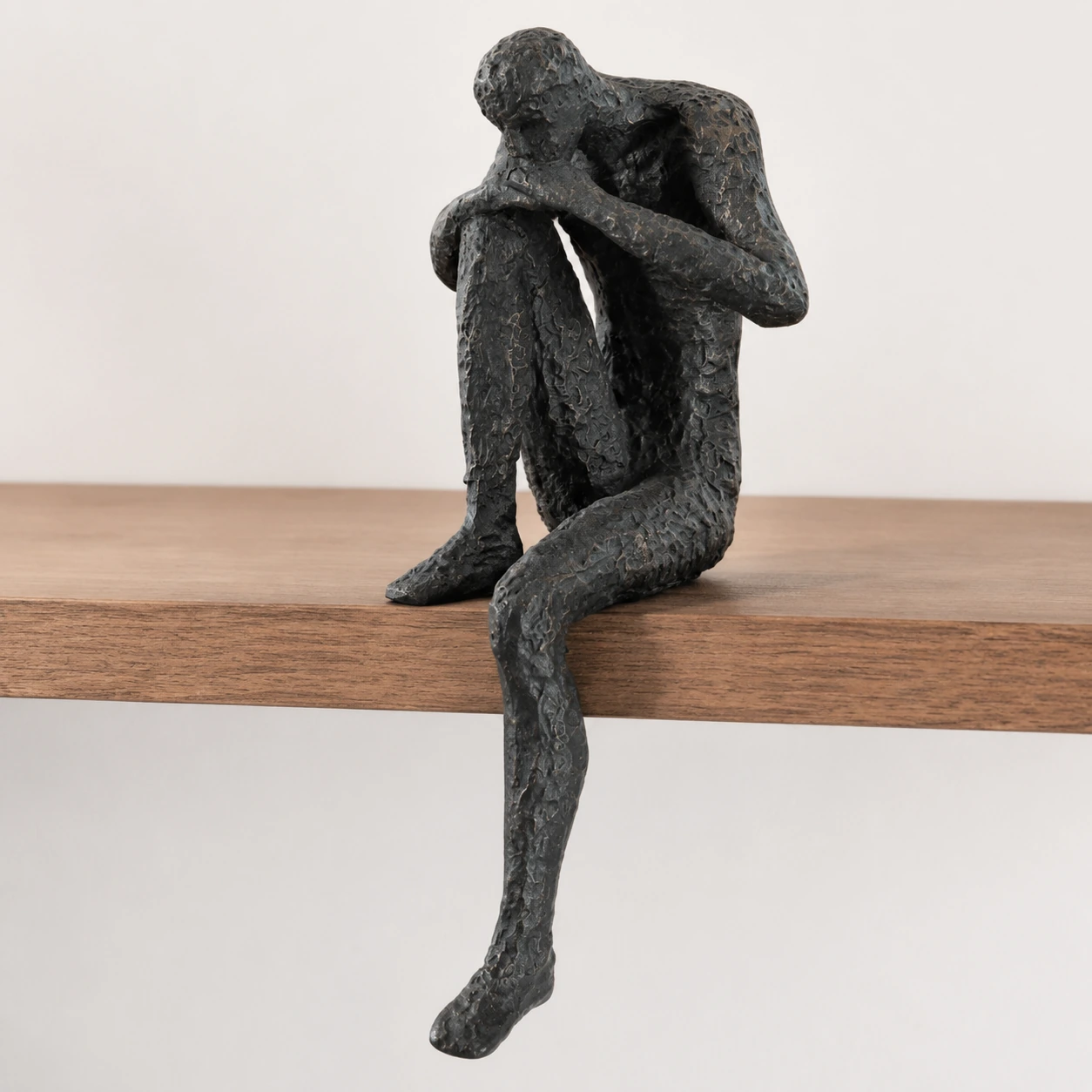 Detail showing how the sculpture rests on a shelf edge