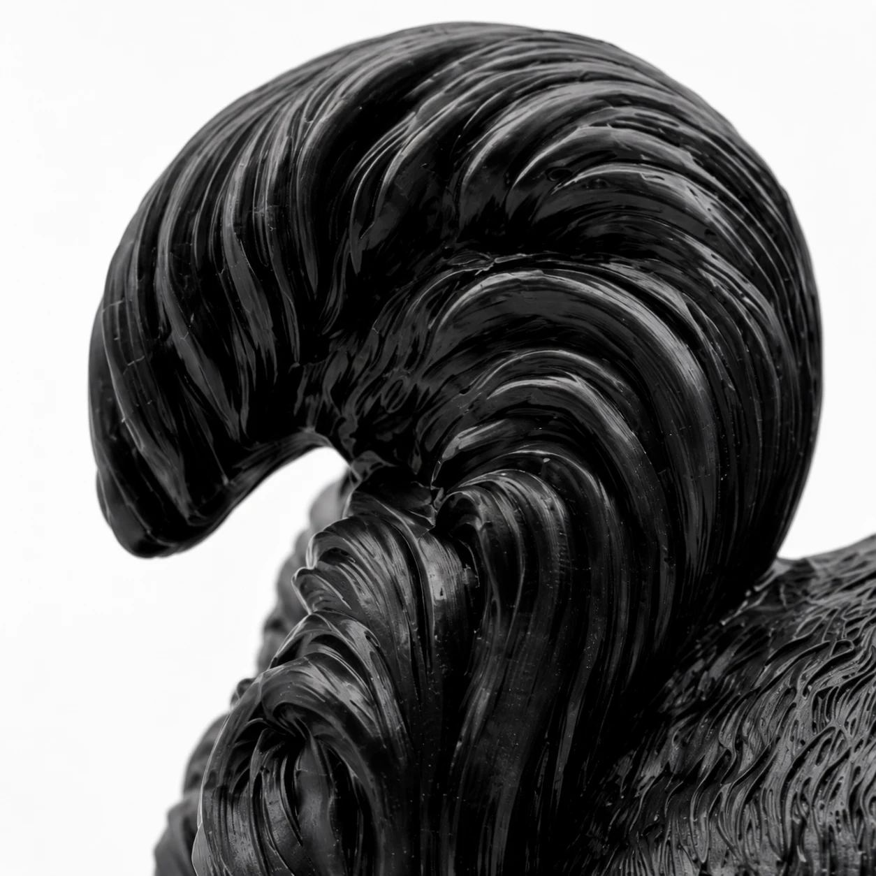 Close view of black curled tail carving