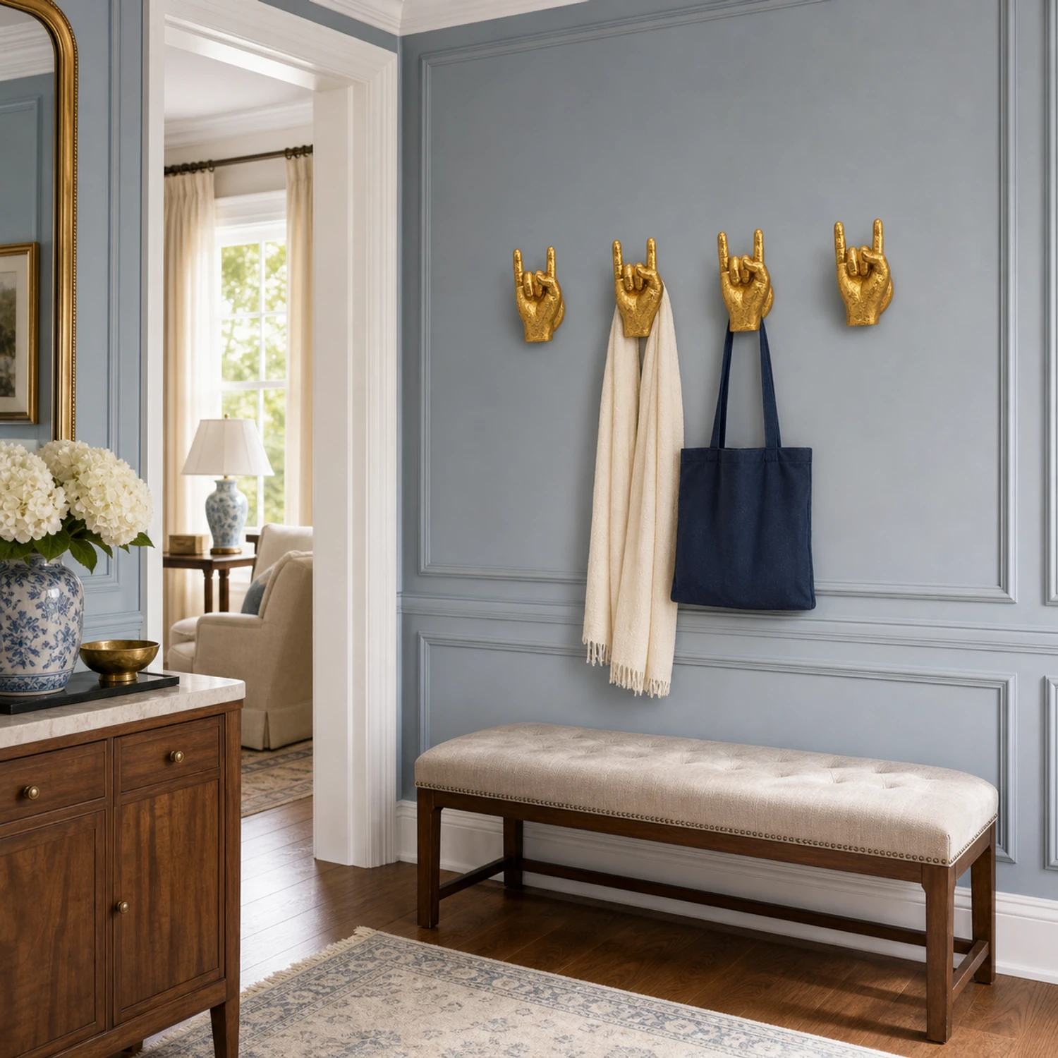 Four gold gesture wall sculptures in a paneled entryway