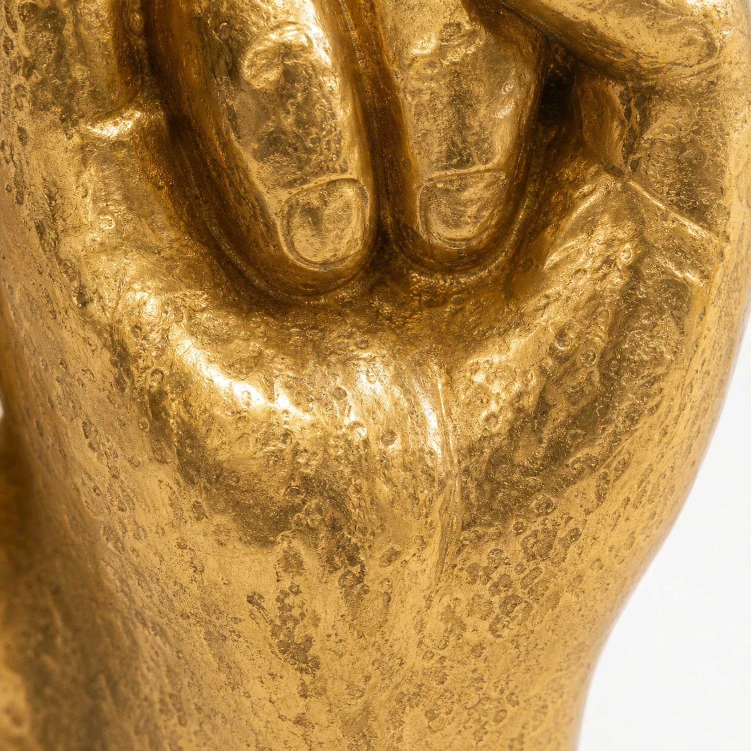 Macro view of the textured antique-gold palm finish