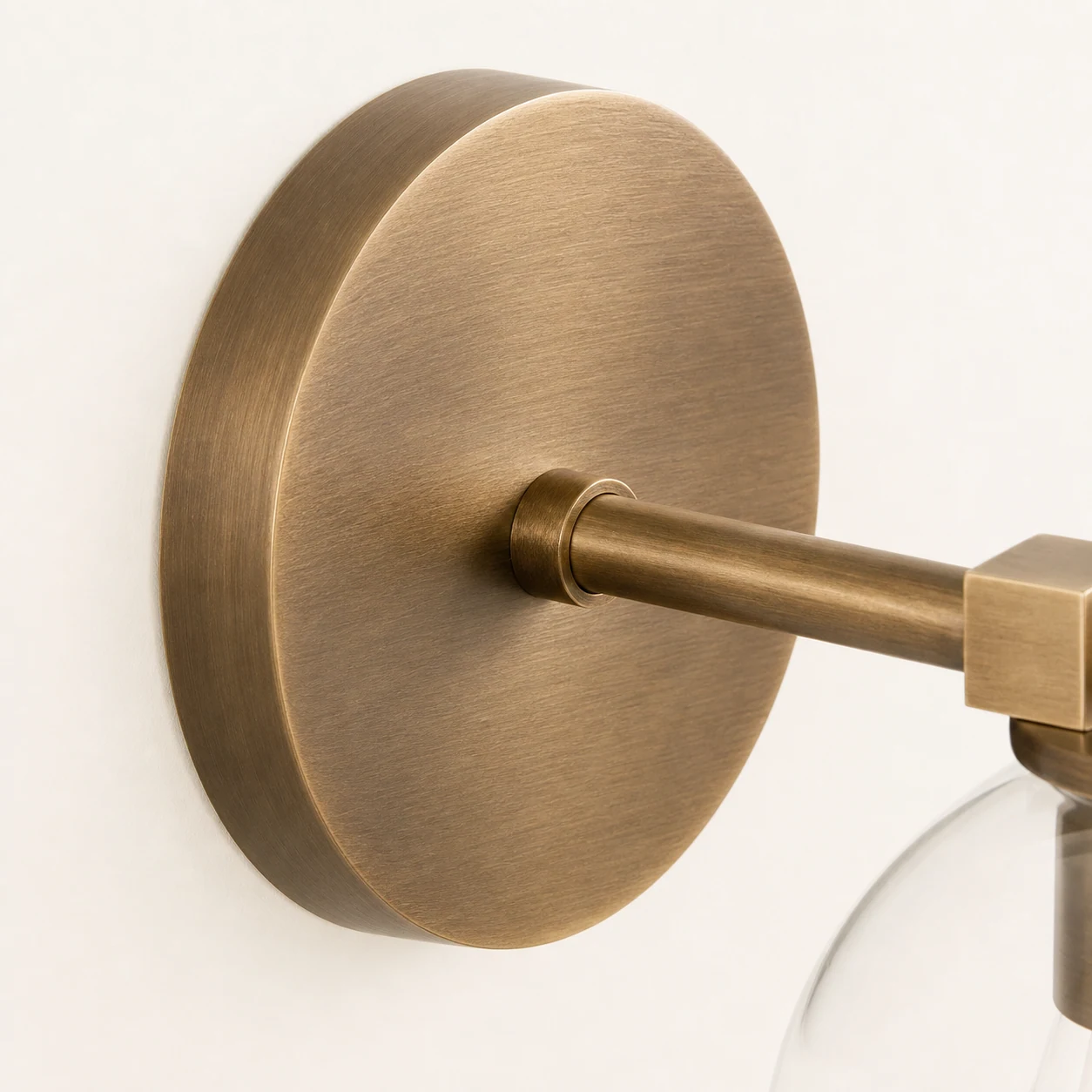 Brushed brass wall plate and arm detail