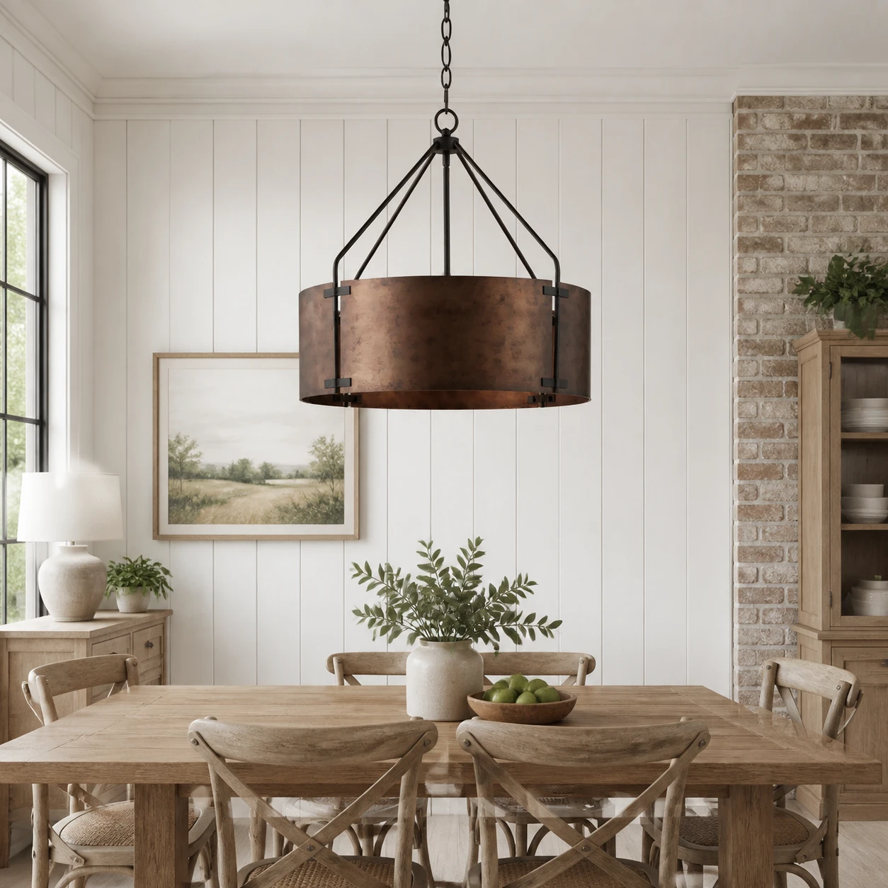 Aged bronze drum pendant in an American farmhouse dining room
