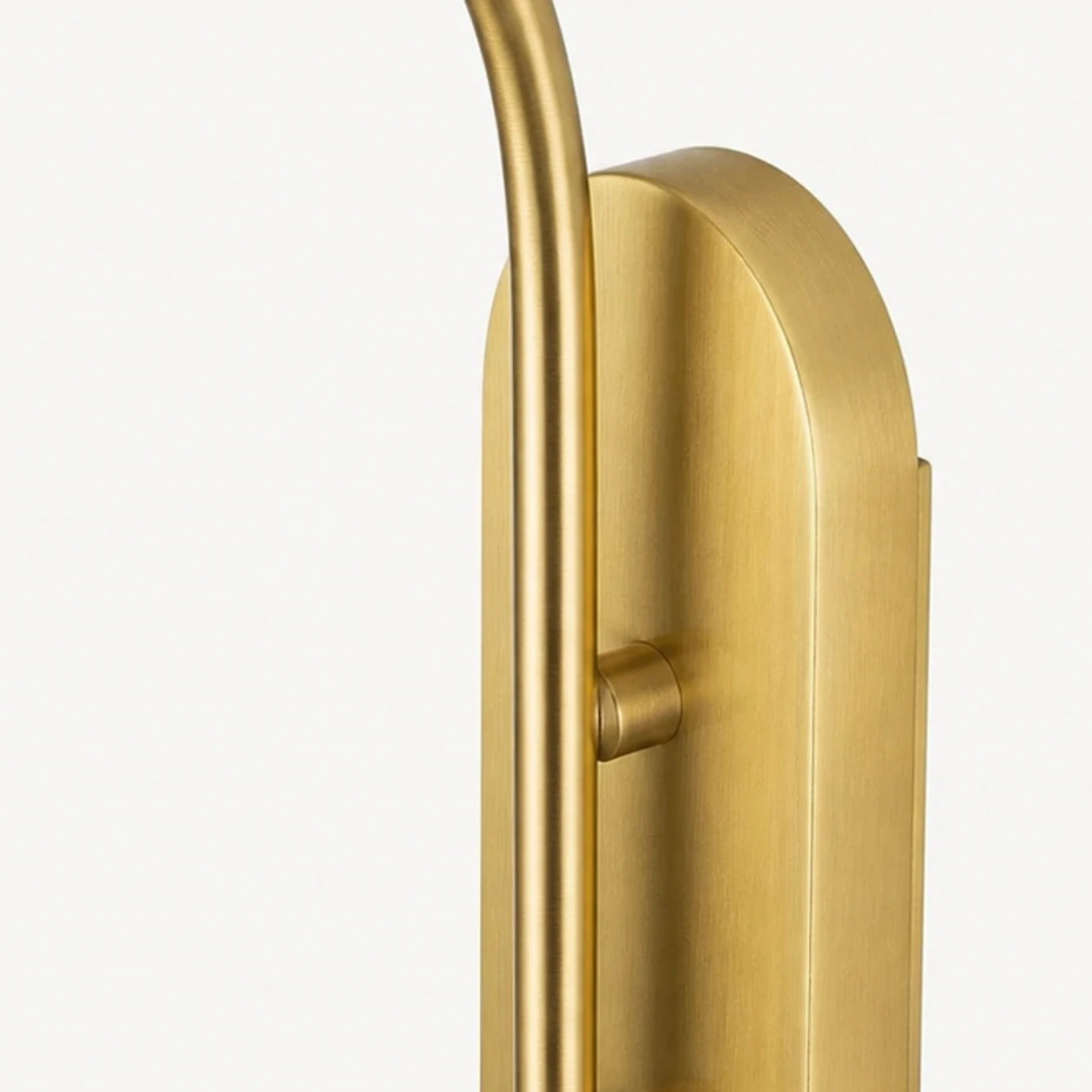 Close detail of gold metal backplate and fixed arm