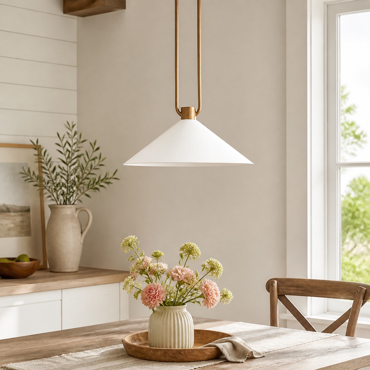White and brass Zane pendant in a sunlit dining nook