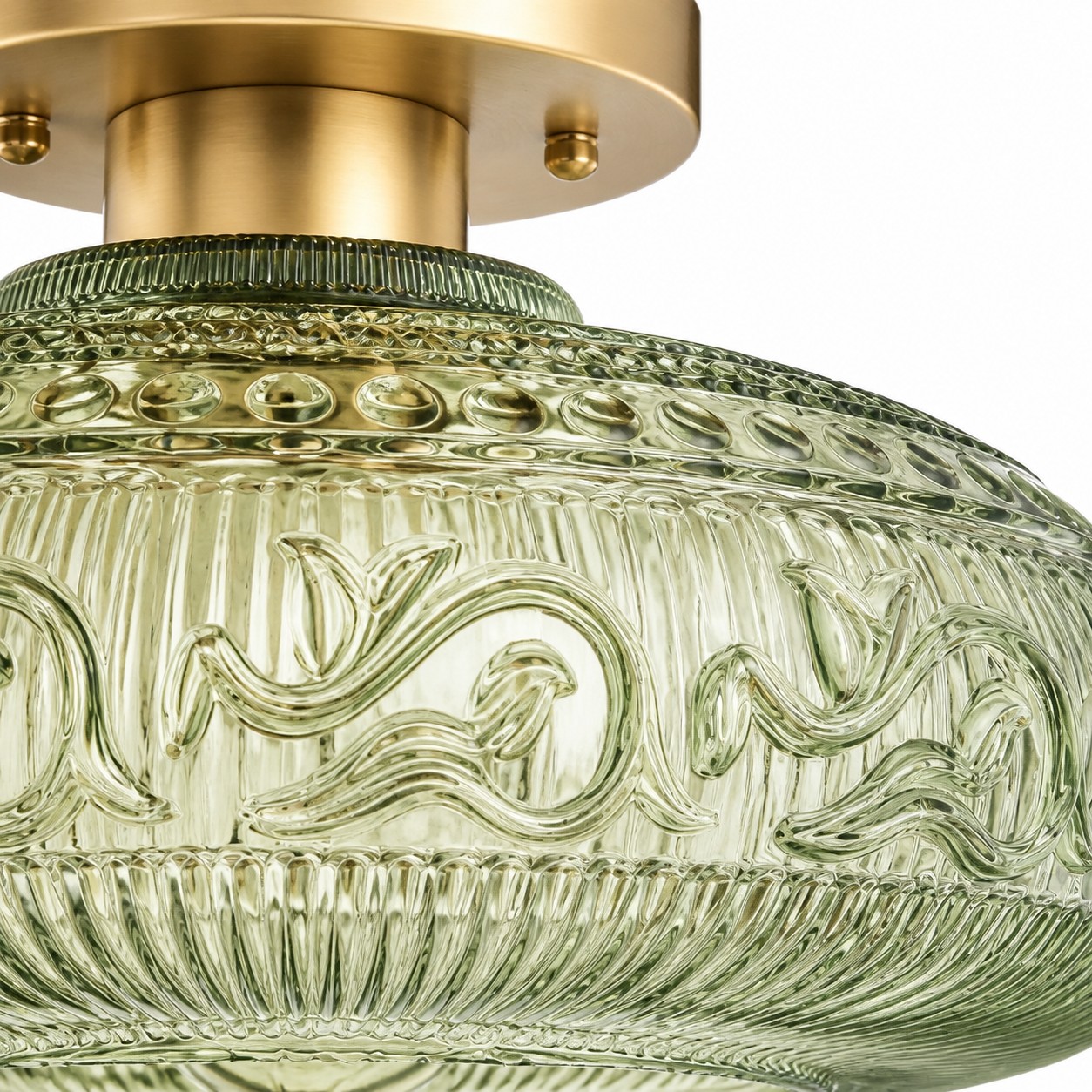 Close view of green engraved glass and brass hardware