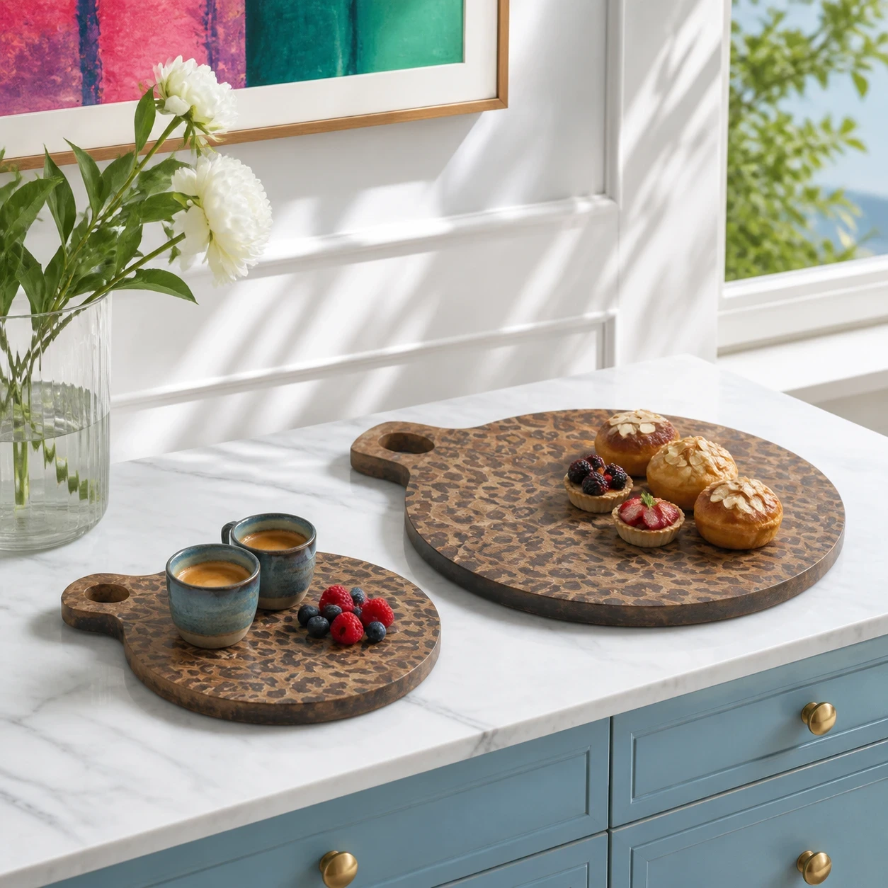 Two Powell serving board sizes arranged on a blue sideboard