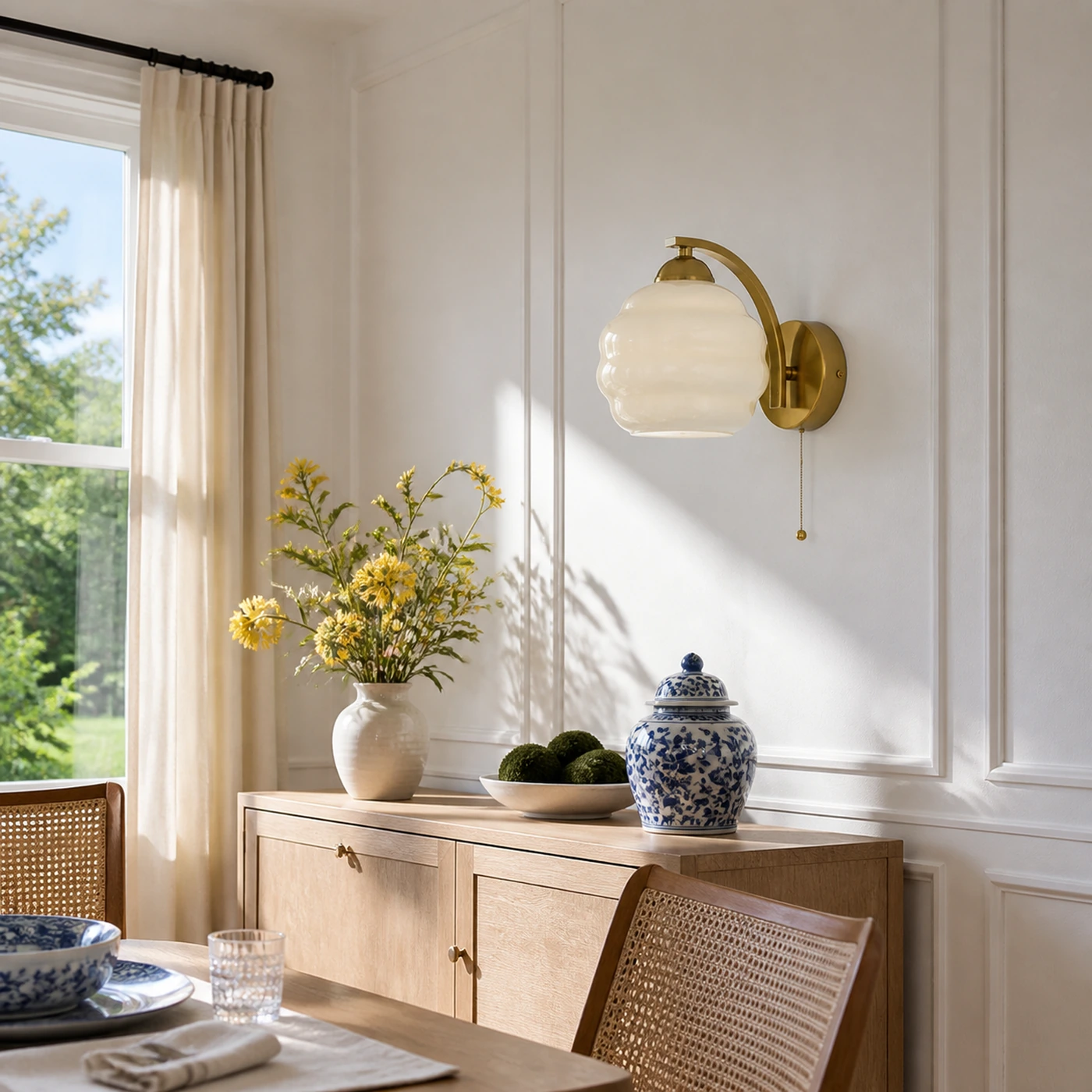 Beige milk glass sconce in a bright dining nook