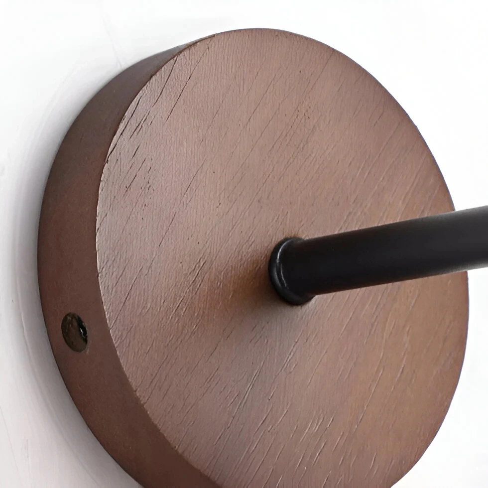 Actual walnut backplate and black metal arm detail