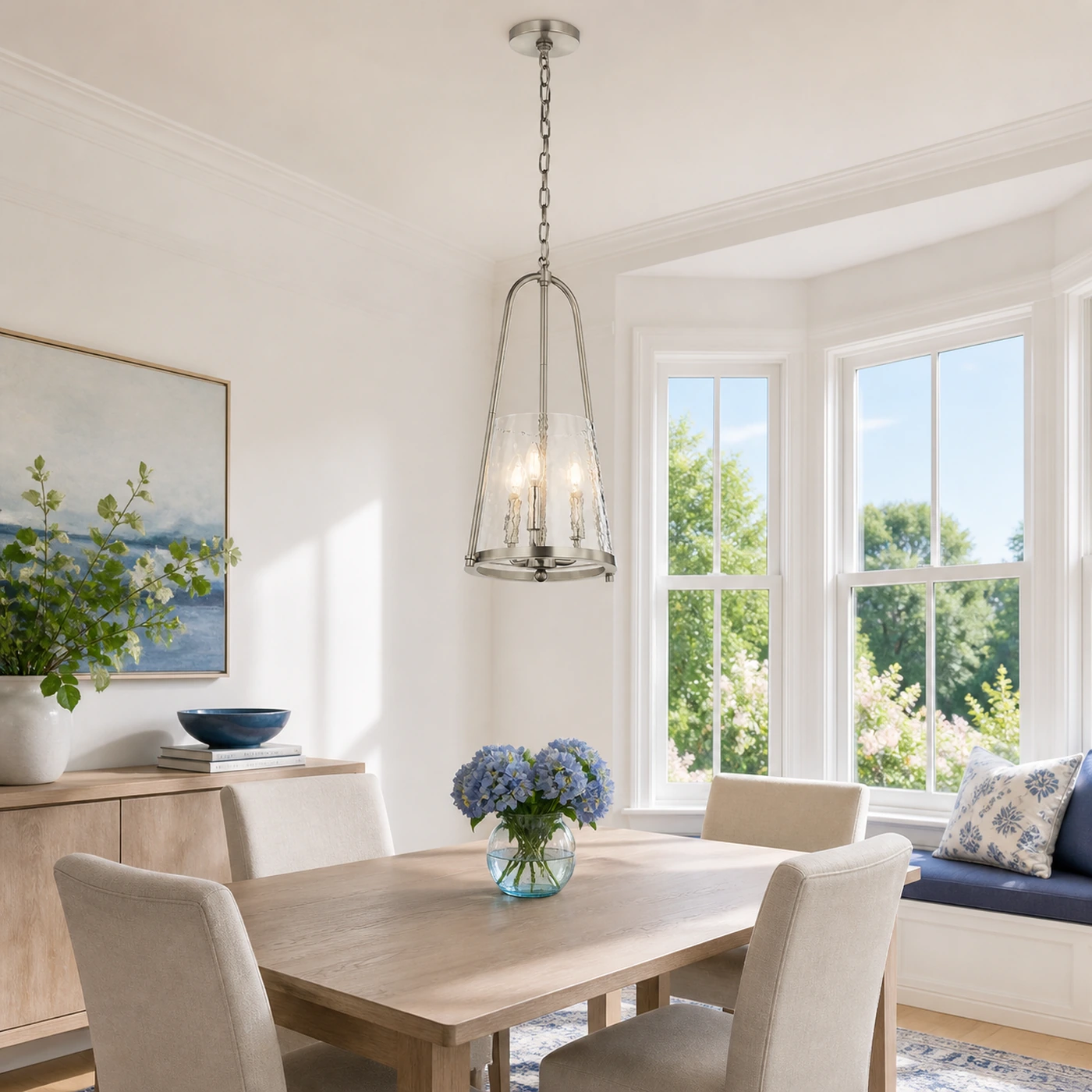 Brushed Nickel Qorlen pendant in a bright dining corner