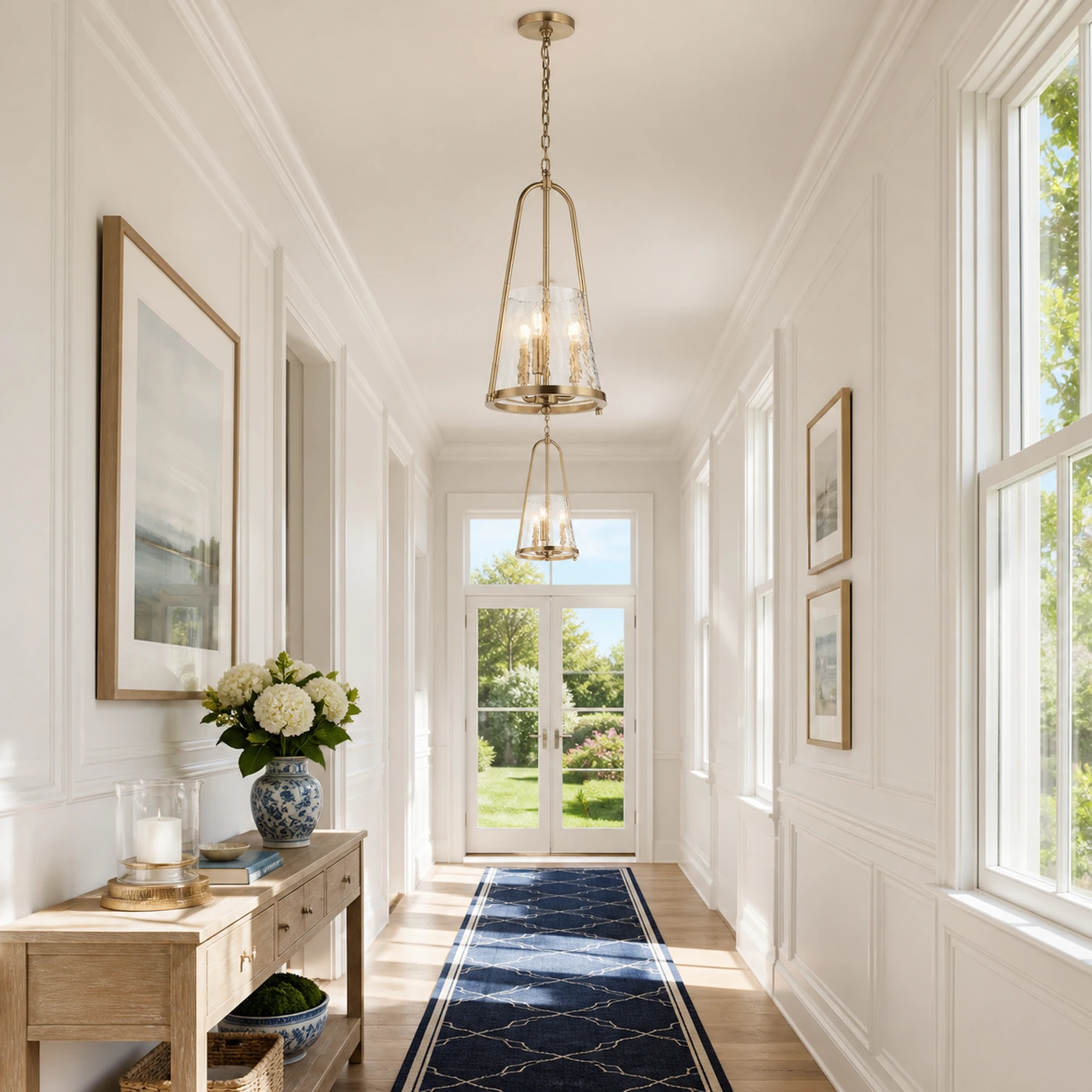 Two Champagne Bronze Qorlen pendants in a bright hallway