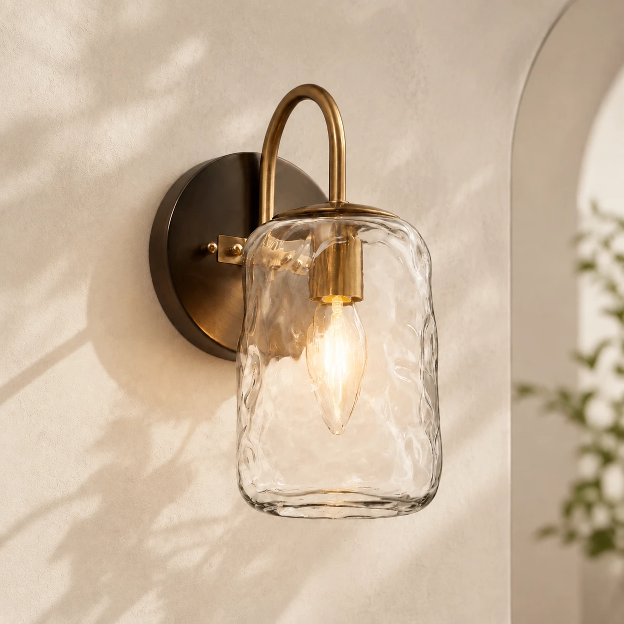 Blythe hammered glass wall sconce glowing warmly