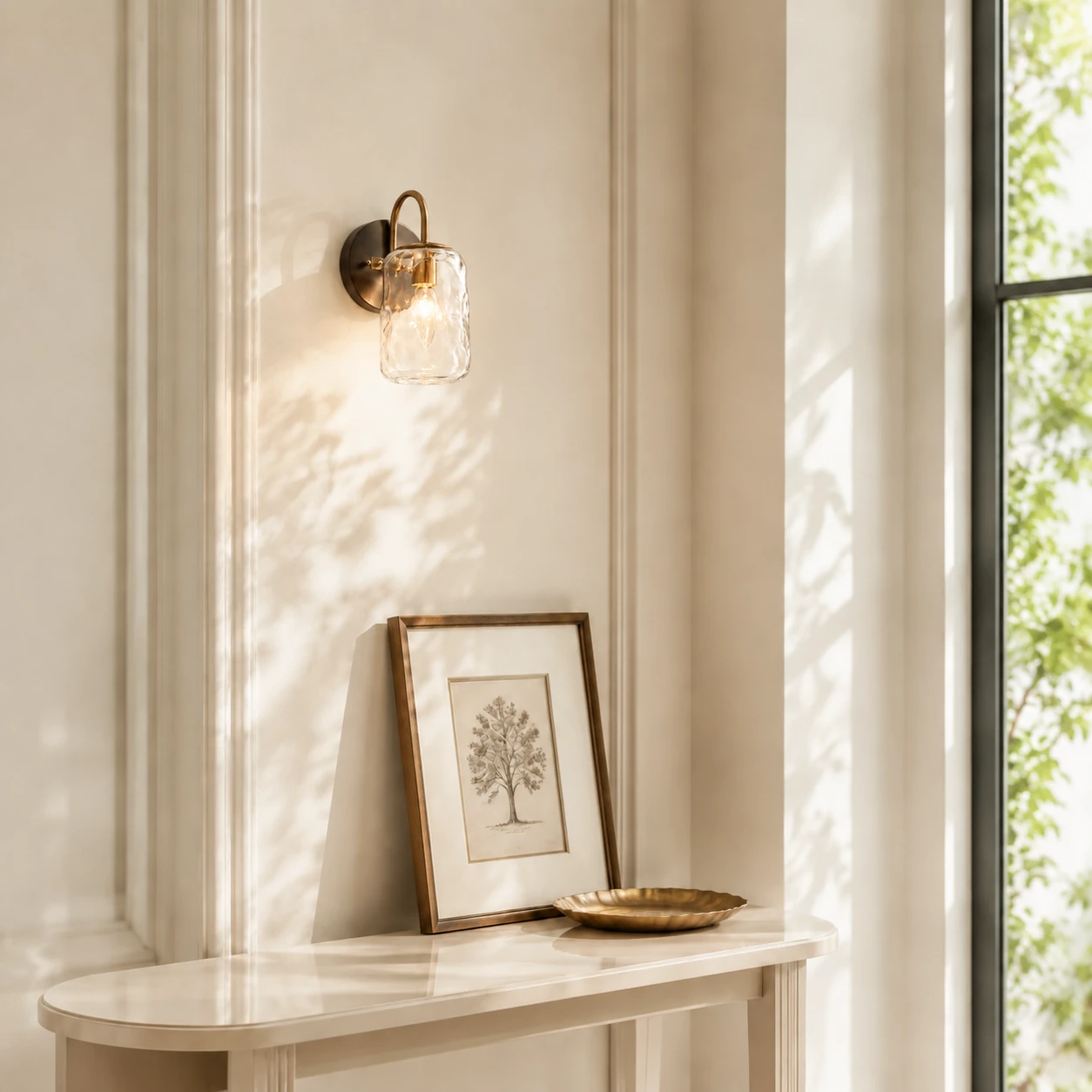 One-light Blythe wall sconce above a slim console in sunlight