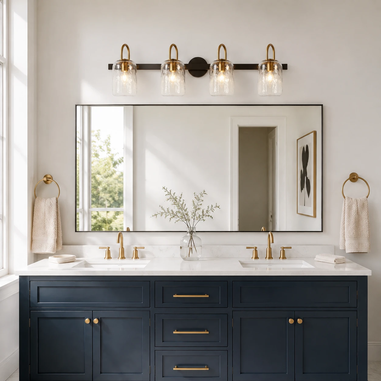 Four-light Blythe wall sconce above a navy double vanity