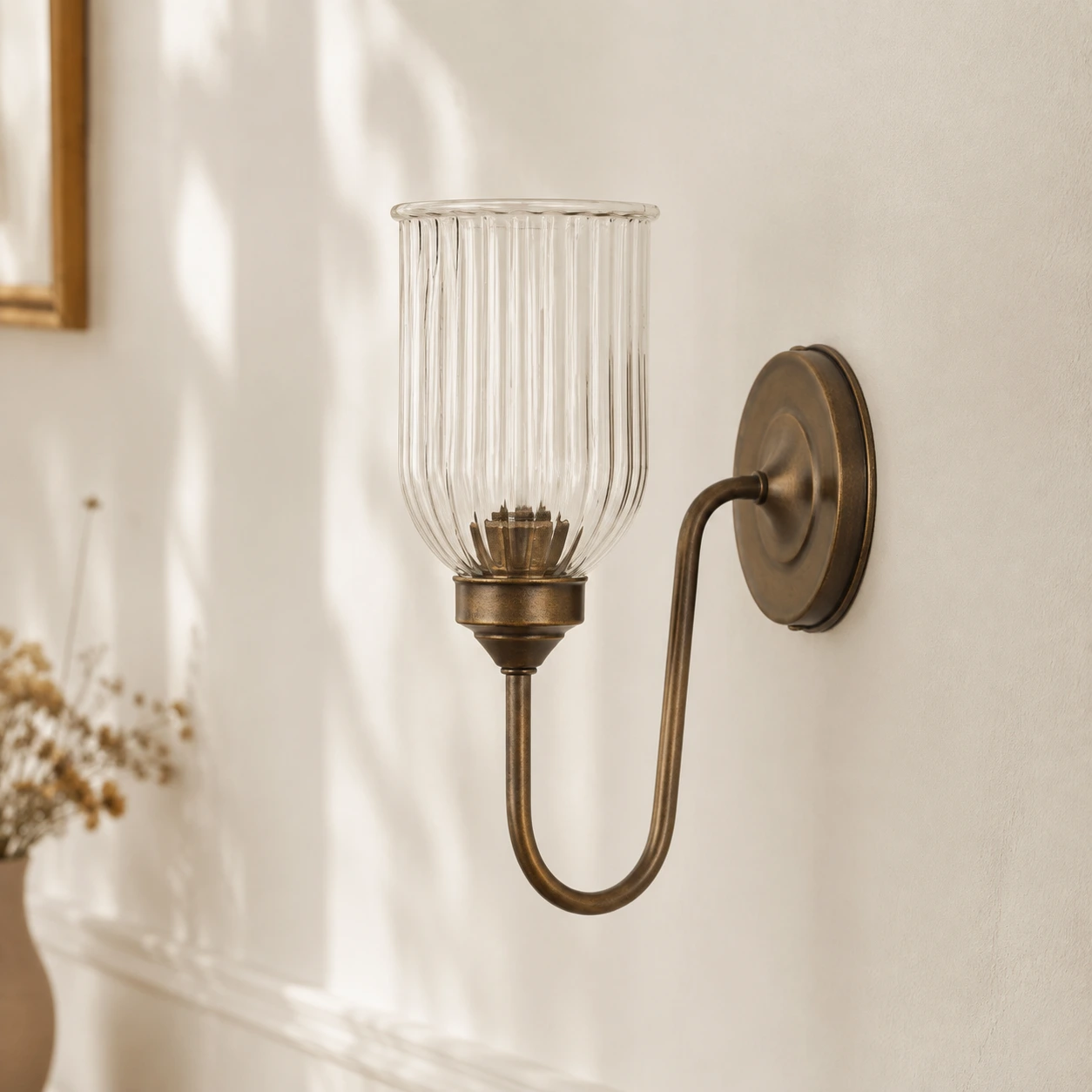 Menae Antique Brass ribbed glass wall sconce in daylight