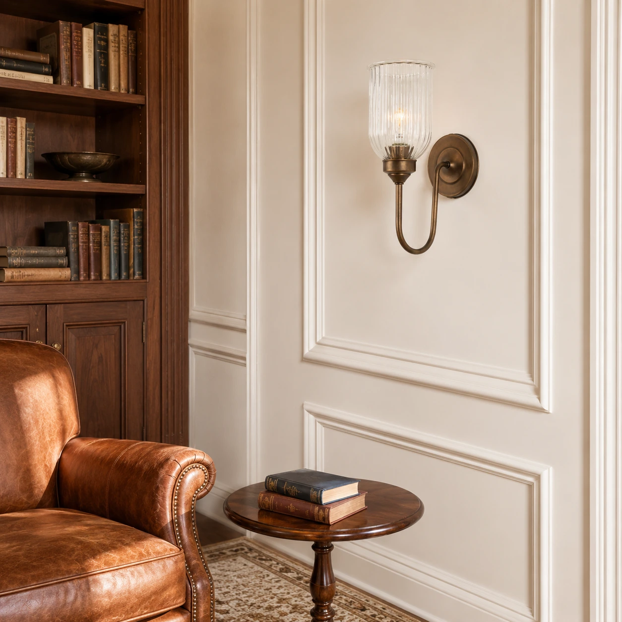 Menae Burnished Brass wall sconce in a home library
