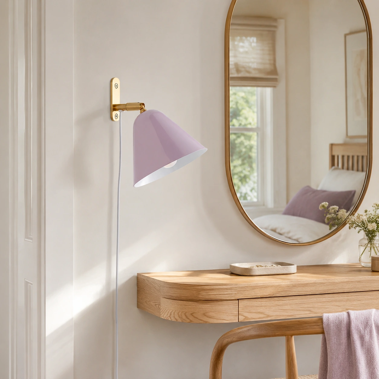 Mauve Phrike wall sconce beside an oval dressing mirror