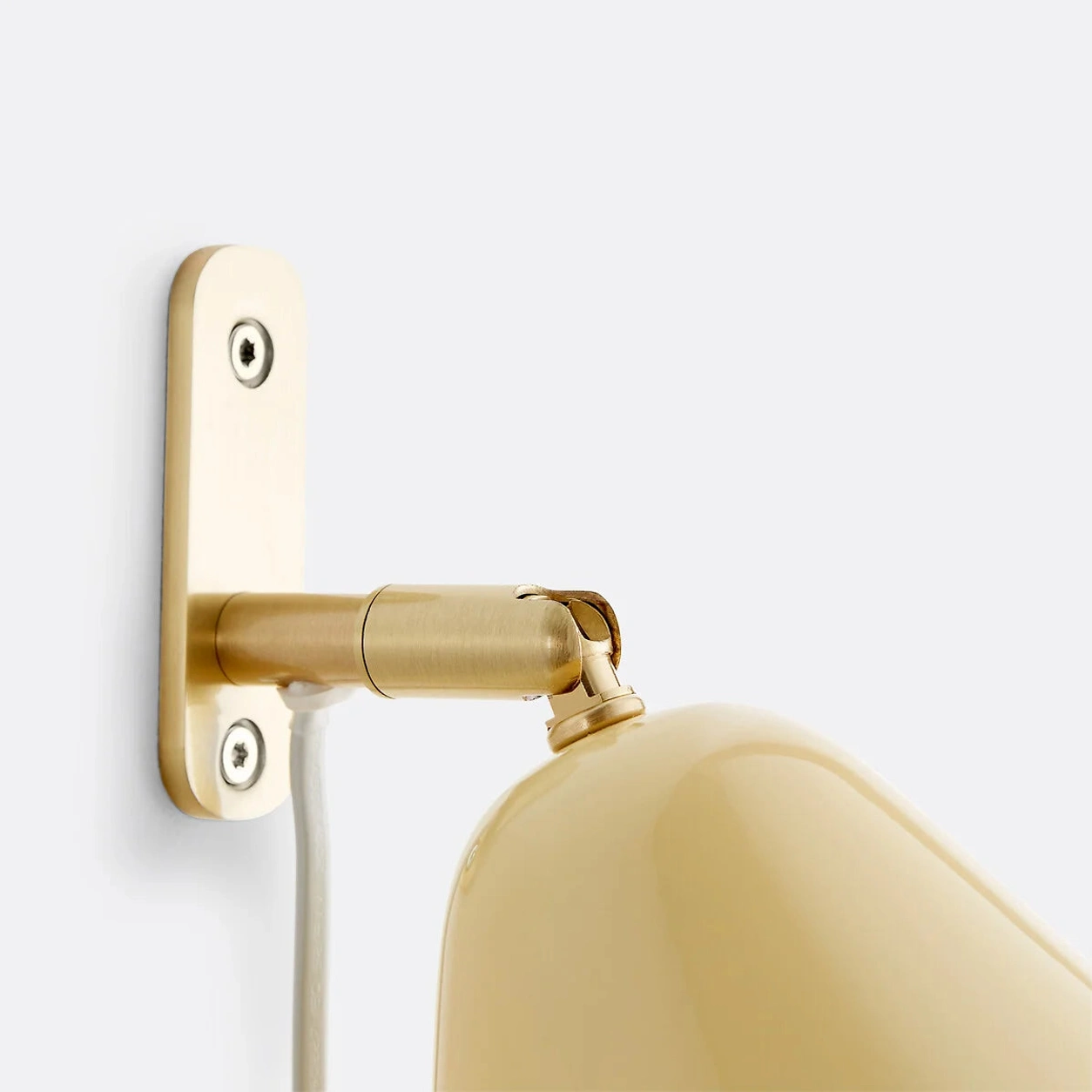 Close-up of the Phrike brass wall plate and arm