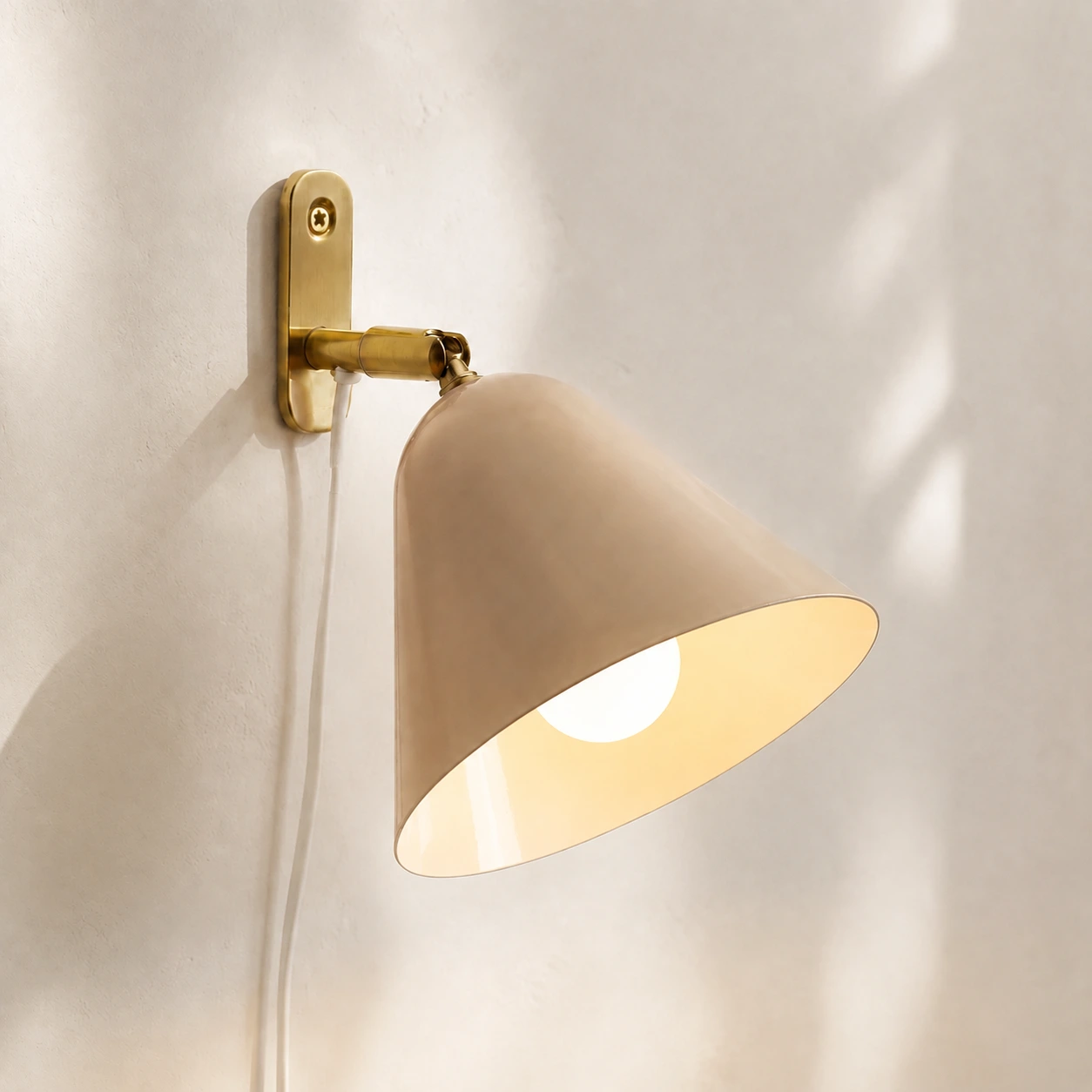 Phrike Vanilla wall sconce with the bulb lit