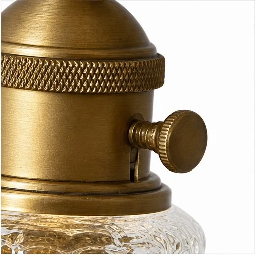 Close view of the Davit pendant light's textured metal collar and side switch